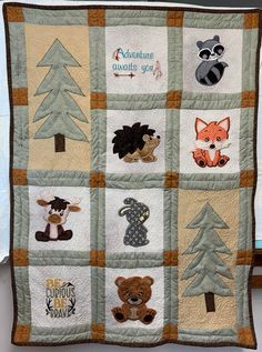 a baby quilt with animals and trees on it