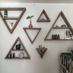 three wooden shelves are arranged on the wall