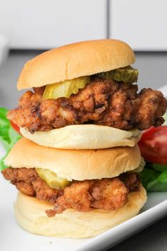 two chicken sandwiches stacked on top of each other