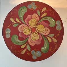 a red and yellow flower painted on the side of a wall