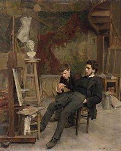 two young men sitting in front of an easel