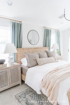 a bedroom with white walls and blue curtains