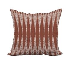 a brown and white pillow with an abstract design on the front, sitting against a white background