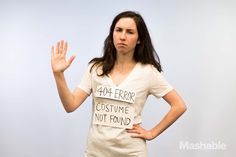 a woman is standing with her hands up