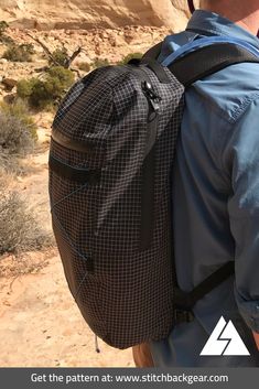 a man with a backpack on his back in the desert