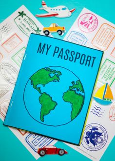 a passport sitting on top of a pile of stickers next to a toy car