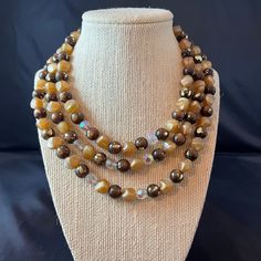 "This listing is for a Coro signed three strand necklace.  The necklace has mostly resin beads in colors of brown with gold splashes, beige, and clear faceted glass.  The necklace also has gold details and a hook clasp. Size:  Approximately 14\" to 17-1/2\" with an additional 2-1/2\" extension Condition:  Good condition for being vintage Want to purchase 3 or more items from my shop?  Please use the following coupon when you check out to receive 20% off! https://www.etsy.com/shop/elsysvintage?co Brown Beaded Necklaces For Parties With Polished Beads, Brown Costume Jewelry Beaded Necklaces For Party, Brown Polished Beads Necklace For Party, Vintage Brown Necklace For Party, Vintage Brown Necklaces For Party, Brown Costume Jewelry Necklace With Polished Beads, Brown Polished Beads Costume Jewelry Necklace, Brown Multi-strand Beaded Necklace With Gold Beads, Vintage Brown Beaded Necklace With Faceted Beads