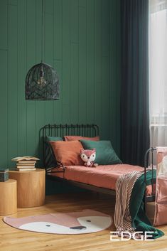 a bedroom with green walls and wooden flooring, a bed in the foreground