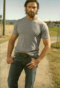 a man standing on a dirt road with his hands in his pockets