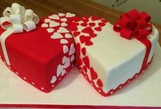 two heart shaped cakes with bows and hearts on them