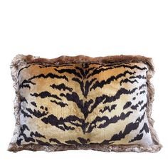 an animal print pillow with fur trimmings on the front and back of it