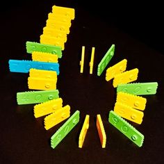 several pieces of plastic are arranged in the shape of a circle on a black surface