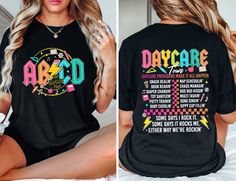 a woman sitting on top of a bed wearing a black shirt with the words, days are