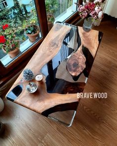 a wooden table sitting in front of a window on top of a hard wood floor