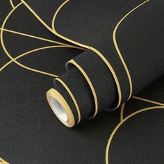 a black and gold wallpaper with lines on it