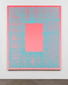 an abstract painting with blue and pink squares in the center, on a white wall