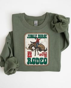 Jingle Horse Rodeo Sweatshirt, Cowboy Christmas Shirt, Christmas Western Shirt, Christmas Gift Shirt, Vintage Christmas T-Shirt Checkout More from Milano Fashion Threads Shop  https://www.etsy.com/shop/Milanofashionthreads?ref=dashboard-header ✨These designs are great gifts for family, friends, or coworkers. Our mentality is every t-shirt we create, we make more impact on the world We use Bella Canvas, Circle Clothing, Gildan Softstyle brands. If there is a specific brand you would like please ad a note to seller at checkout. Available inventory is sent when none is specified.* ✨SHIRT SIZING All Shirts come in 14 colors and 5 sizes, ranging from Small to 2X-Large.  Unisex T-Shirts are regular fit. They tend to run slightly large for women if you want an oversized fit you can order 1 or 2 s Horse Rodeo, Christmas Western, Milano Fashion, Dashboard Header, Cowboy Christmas, Western Shirt, Christmas T Shirt, Western Shirts, Christmas Shirt