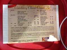 a menu for cranberry cheesecake pie on a red plate with a piece of paper attached to it