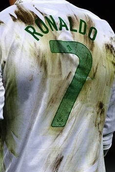 the back of a man's shirt with brown and green paint on it