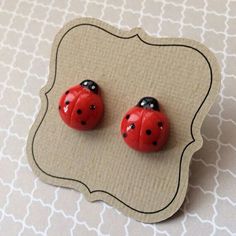 pair of ladybug earrings with black dots on red ear studs for girls