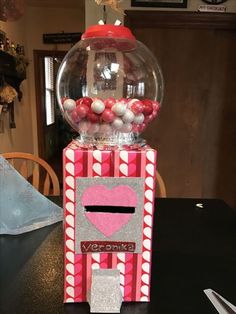 a gum ball machine is sitting on top of a table