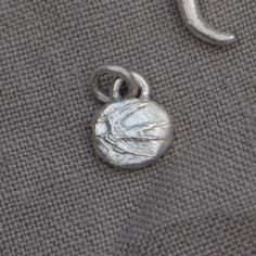 The enigmatic swift as a symbol of freedom features in flight upon this talisman. Hand carved in jewellers wax and cast into recycled eco silver. The image conjours up memories of summer, carefree moments, in awe of the Swift's playful nature, imagine the joyful ambiance of their calls as they fly past. This pendant charm is carved in jewellers wax and cast using the ancient 'Lost Wax Casting Method' and hand finished in the Lunaflux home studio.. This order is accompanied by; 🌛 Complimentary s Nature-inspired Sterling Silver Moon Charm Jewelry, Silver Moon Charm Pendant, Wax Carving Jewelry, Symbol Of Freedom, Silver Bird, Wax Carving, Bird Pendant, Casting Jewelry, Wax Casting