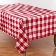 a red and white checkered table cloth on a wooden wheel