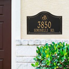 a sign on the side of a building that reads 350 simonellelli rd in gold lettering