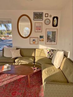 a living room filled with furniture and pictures on the wall