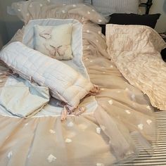 an unmade bed with two pillows on top of it and one pillow is laying down