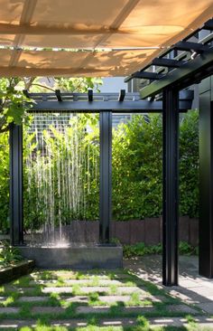 an outdoor shower in the middle of a garden