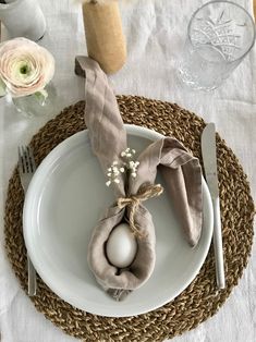 a place setting with an egg and napkin