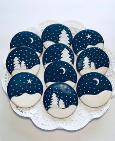 blue and white decorated cookies with trees on them