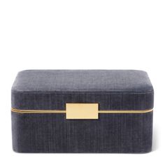 a blue velvet box with gold trimmings on the top and bottom, sitting against a white background