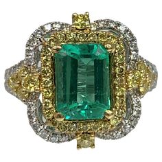 An exquisite and exceptional one- of- a kind colorful ring featuring an bright emerald cut emerald weighing 1.68 carats accented by 0.53 carats of yellow diamonds and 0.58 carats of white diamonds. *Approximate stone measurements: Height: 9mm Width: 7mm Approximate ring weight: 5.53 grams Colorful Ring, Stunning Aesthetic, Blessed Wednesday, Yellow Diamond Ring, Emerald Ring Vintage, Emerald Rings, Expensive Jewelry Luxury, Yellow Diamonds, Yellow Diamond Rings