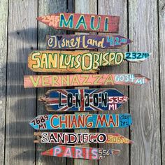 a wooden sign with many different languages on it