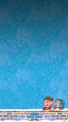 two children are sitting on a ledge looking at the snowflakes in the sky