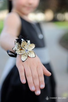 "This beautiful corsage is crafted out of 5 small paper flowers personalized with the colors of your choice and accented with the embellishments of your choice. Each flower is made from the pages of a book, classical pieces of sheet music, or solid colors. They are securely attached to a piece of satin ribbon to be tied comfortably around your wrist. The is subtle accessory will bring a touch of elegance to your next party, prom or wedding accessory! The photos feature several different corsages Mother Of The Bride Accessories, Wrist Corsage Prom, Origami Wedding, Folding Origami, Corsage Prom, Prom Flowers, Flower Corsage, Corsage Wedding, Wrist Wrap