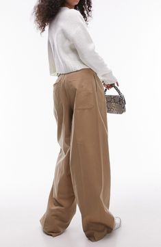 An office-official pants style clearly heads out for the weekend with a highwaist and a really roomy cut. 30 1/2" inseam; 24" leg opening; 14 1/2" front rise; 17" back rise (size 8) Zip fly with hook-and-bar closure Front slant pockets; back patch pockets 53% cotton, 47% lyocell Machine wash, dry flat Imported Chic Wide-leg Work Pants With Pockets, Relaxed Fit Office Bottoms With Pockets, Fall Workwear Full-length Cargo Pants, Wide-leg Cargo Pants For Work With Welt Pockets, Wide-leg Cargo Pants For Work, Full-length Cargo Pants For Workwear In Spring, Full Length Cargo Pants For Workwear In Spring, Office Bottoms With Side Pockets For Spring, Spring Office Bottoms With Side Pockets