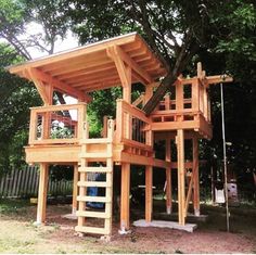 a large wooden structure sitting under a tree