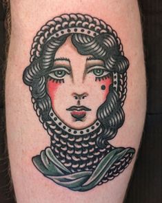 a woman's face with braids on her head is shown in this tattoo