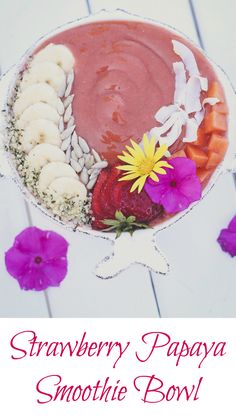 strawberry papaya smoothie bowl with flowers on the side and text overlay that reads, strawberry papaya smoothie bowl