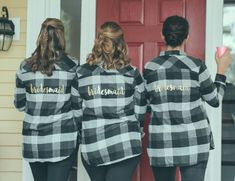 two women in matching flannel shirts are standing outside the door