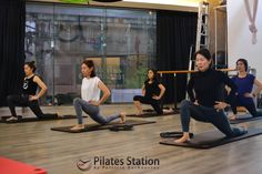 a group of people doing yoga in a room