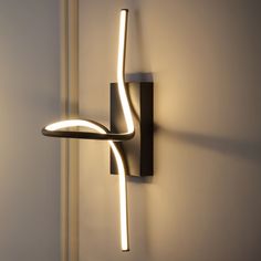 a wall mounted light that is on the side of a wall next to a door