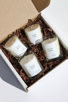 three candles in a box on a table