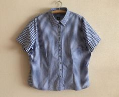 "Blue Gingham Shirt Plaid Dirndl Blouse Checkered Trachten Shirt Blue White Plaid Blouse Short Sleeve Cotton Top Plus Size Extra Large   Label size: 54/56 EUR, 28 UK Measurements (lying flat): Length: 27.5\"/ 70 cm Shoulder: 19\"/ 48 cm Pit to pit: 28\"/ 71 cm Sleeve: 9.5\"/ 24 cm Please check measurements to insure a proper fit. Remember to allow yourself some extra room for movement. You can compare these with something from your closet that fits you well. Condition: Great Vintage Condition Material: 100%cotton N.B. Color may slightly differ from picture SHIPPING * I ship worldwide via Priority mail * Items are shipped 1 - 3 business days after receiving the payment. * I ship from Europe, so please allow 2 to 4 weeks for the package to arrive if you live overseas. * Europe 5 - 10 busines Gingham Button Up Shirt Outfit, Short Sleeve Gingham Blouse For Work, Gingham Short Sleeve Blouse For Work, Classic Fitted Gingham Blouse, Short Sleeve Gingham Shirt For Work, Gingham Short Sleeve Shirt For Workwear, Gingham Short Sleeve Shirt For Work, Patterned Button Up, Gingham Shirt Outfit