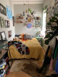 a bed room with a neatly made bed and lots of clutter