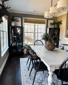 the dining room table is surrounded by black chairs