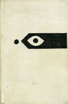 an old book with a black and white eye on the front cover that is open